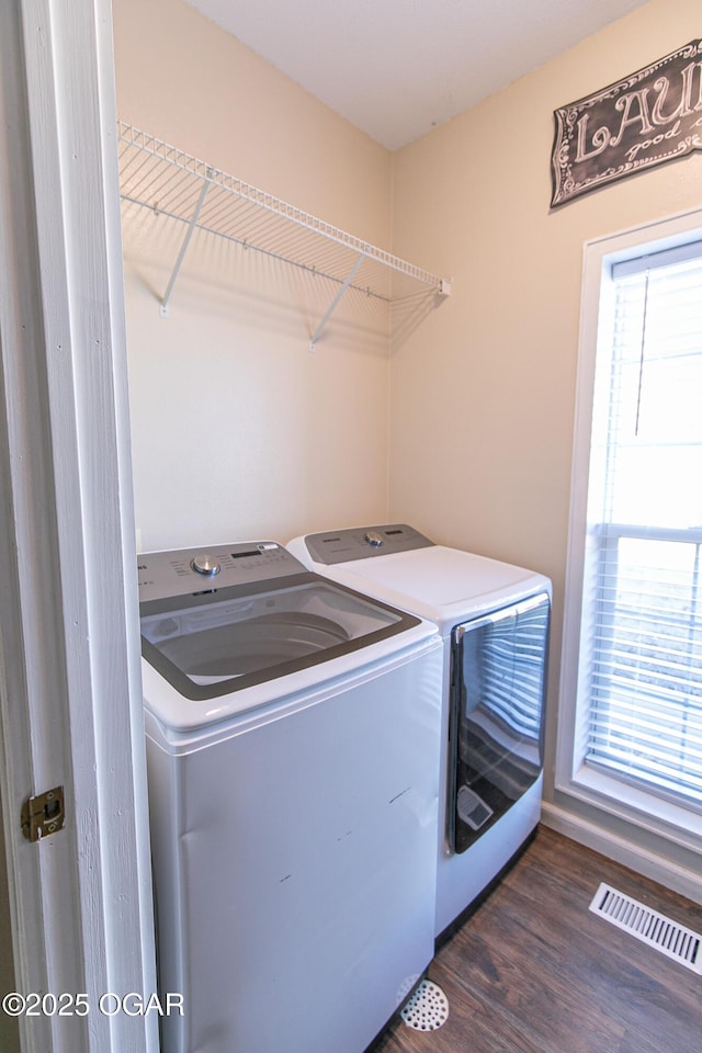 washroom with dark wood-type flooring and washing machine and clothes dryer