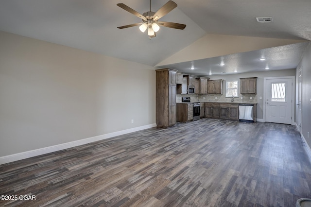 unfurnished living room with sink, dark wood-type flooring, and vaulted ceiling