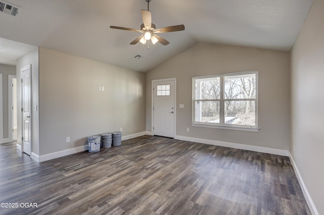 interior space featuring dark hardwood / wood-style flooring, vaulted ceiling, and ceiling fan