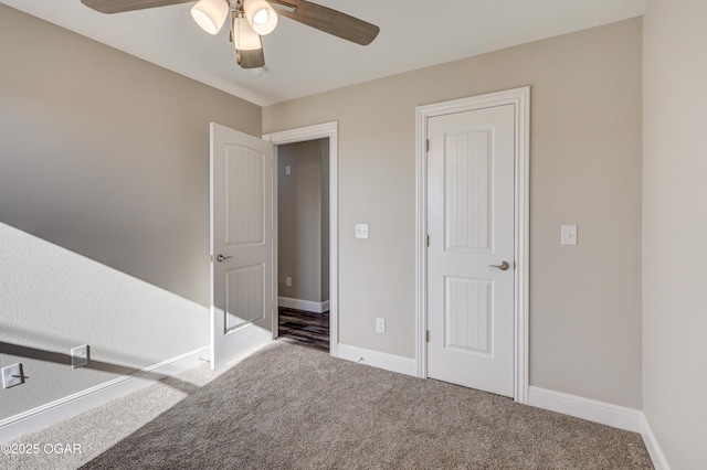 spare room featuring ceiling fan and carpet