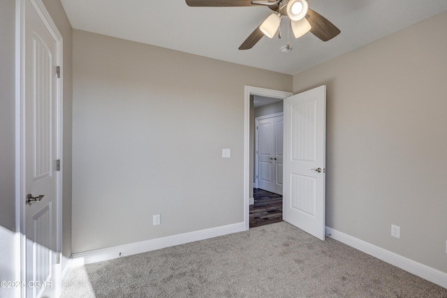 unfurnished bedroom with light colored carpet and ceiling fan