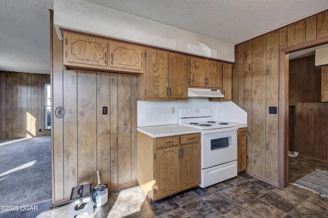 kitchen featuring white electric range, a textured ceiling, and wooden walls