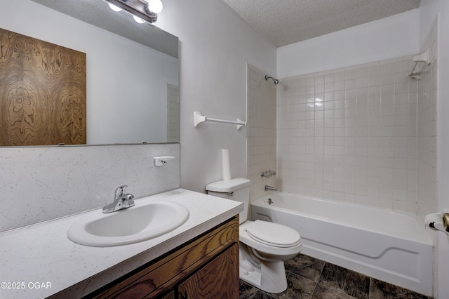 full bathroom featuring decorative backsplash, tiled shower / bath combo, vanity, toilet, and a textured ceiling