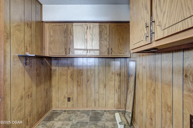 washroom featuring wood walls