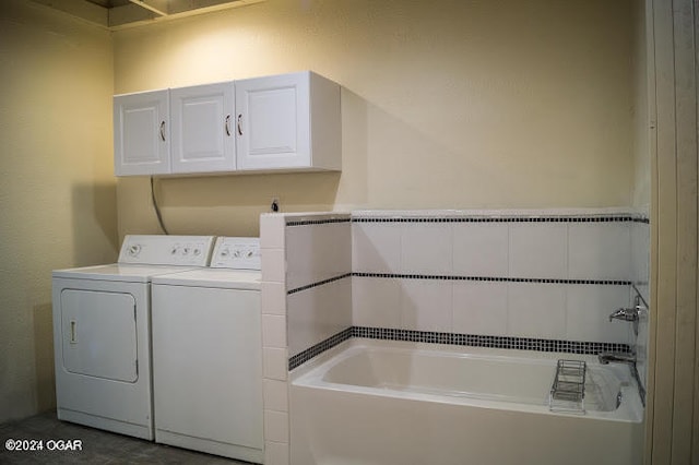 laundry area featuring separate washer and dryer and cabinets