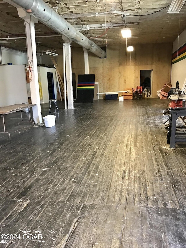 basement with hardwood / wood-style flooring