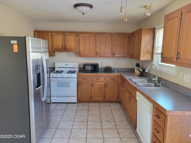 kitchen featuring light tile patterned flooring, sink, and white appliances