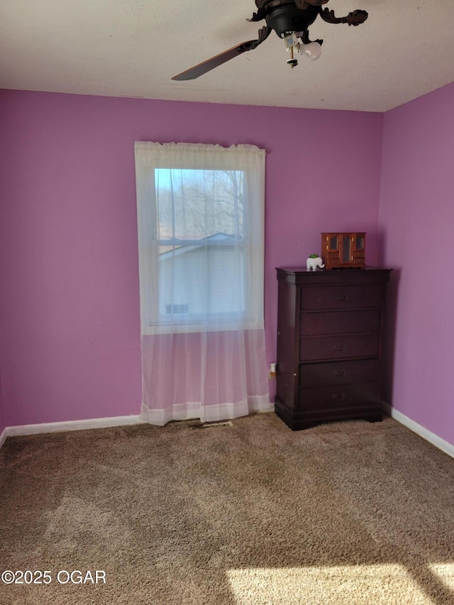 unfurnished bedroom with ceiling fan and carpet