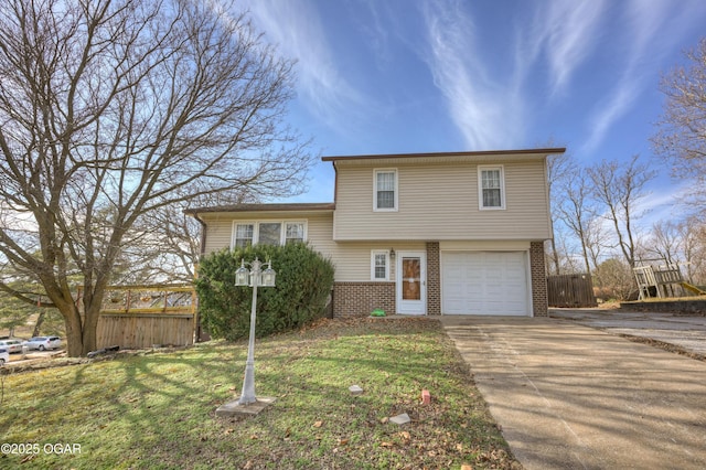 split level home featuring a garage and a front yard