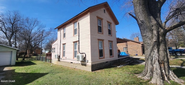 view of side of home featuring crawl space and a lawn