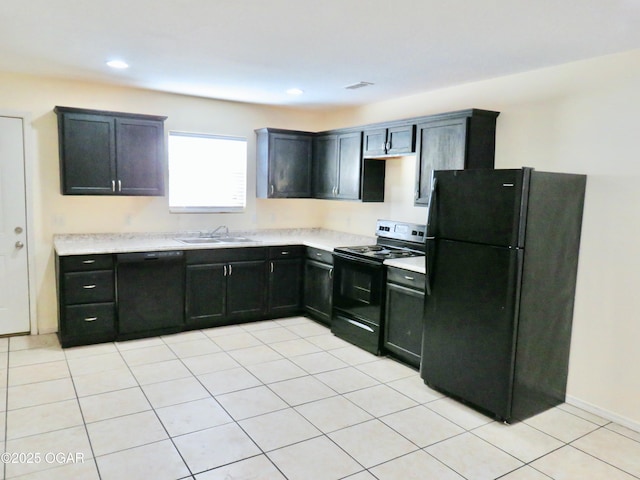 kitchen featuring sink, light tile patterned floors, and black appliances