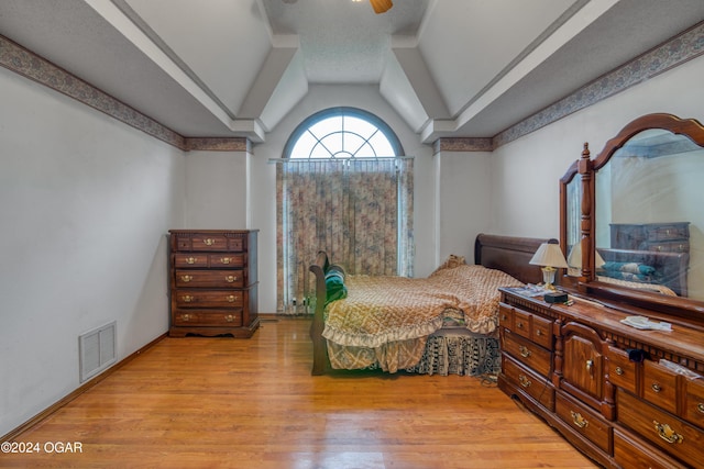 bedroom featuring lofted ceiling and light wood-type flooring