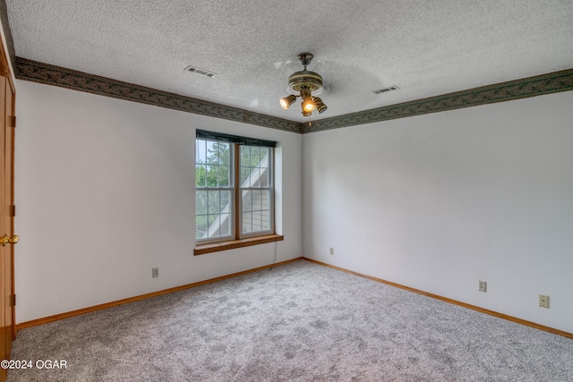 carpeted empty room with a textured ceiling and ceiling fan