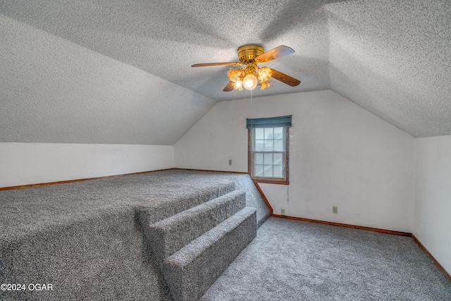 bonus room featuring lofted ceiling, a textured ceiling, and carpet