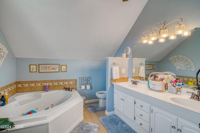 bathroom featuring vaulted ceiling, a bathing tub, vanity, toilet, and tile patterned floors