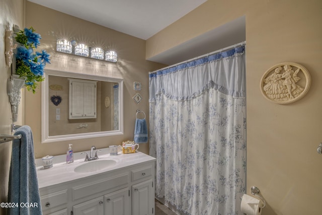 bathroom featuring vanity and curtained shower