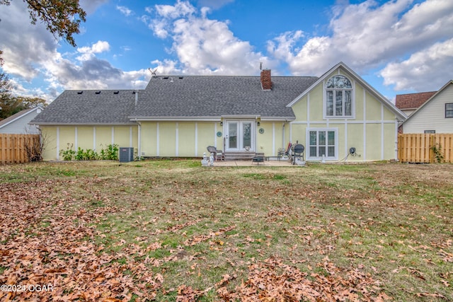 rear view of house featuring a patio, cooling unit, and a lawn