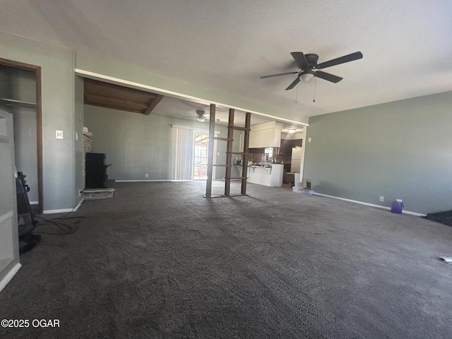 unfurnished living room with dark carpet and ceiling fan