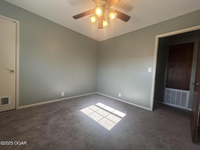 spare room featuring ceiling fan and dark colored carpet