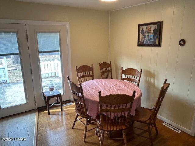 dining room featuring plenty of natural light and wood-type flooring