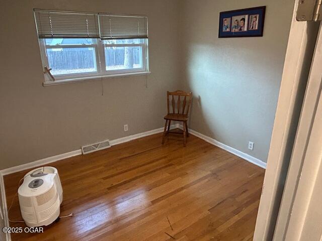 unfurnished room featuring hardwood / wood-style floors