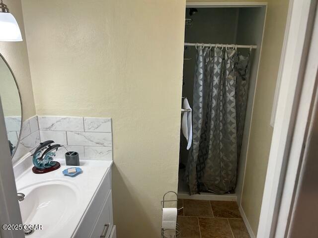 bathroom with vanity and a shower with shower curtain