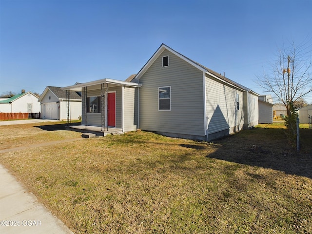 view of front of house featuring a porch, a garage, and a front lawn