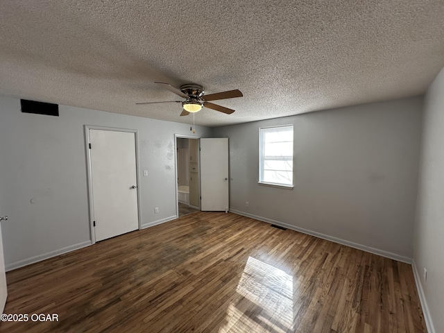 unfurnished bedroom featuring dark wood-type flooring, ceiling fan, and a textured ceiling