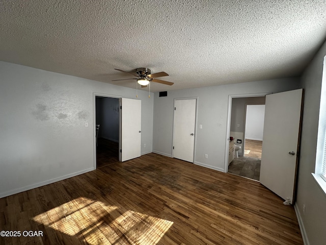 unfurnished bedroom with ceiling fan, a textured ceiling, and dark hardwood / wood-style flooring