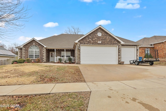 ranch-style home with a garage, a porch, and a front yard