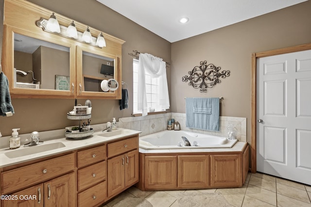 bathroom with vanity, a tub, and tile patterned floors