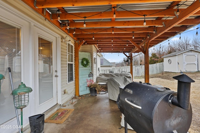 view of patio / terrace with a grill and a shed