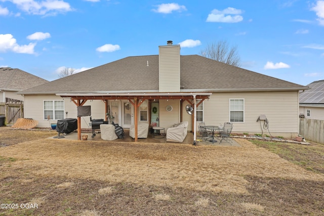 back of house featuring a yard and a patio area