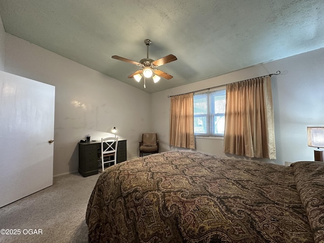 bedroom with ceiling fan, vaulted ceiling, and light carpet