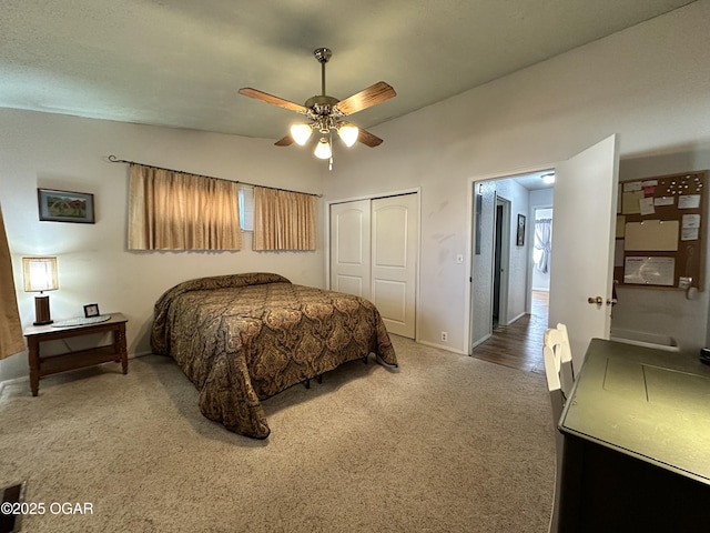 carpeted bedroom featuring lofted ceiling, ceiling fan, and a closet