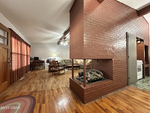 interior space with ceiling fan, hardwood / wood-style floors, and a fireplace