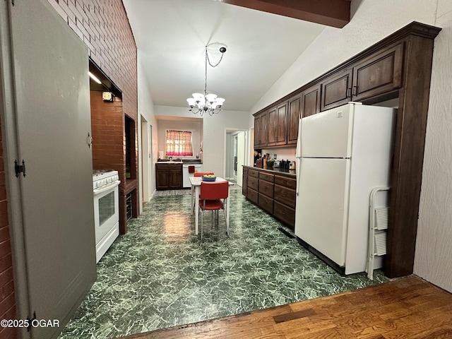 kitchen with dark brown cabinetry, vaulted ceiling, an inviting chandelier, and white appliances