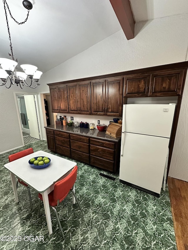 kitchen featuring vaulted ceiling with beams, a notable chandelier, dark brown cabinets, and white fridge