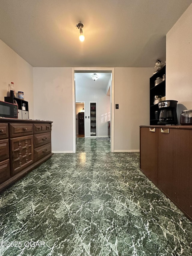 kitchen featuring dark brown cabinets