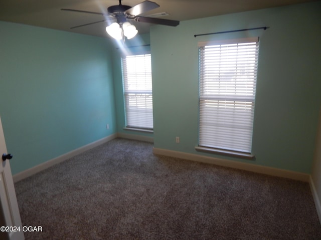 carpeted spare room featuring ceiling fan