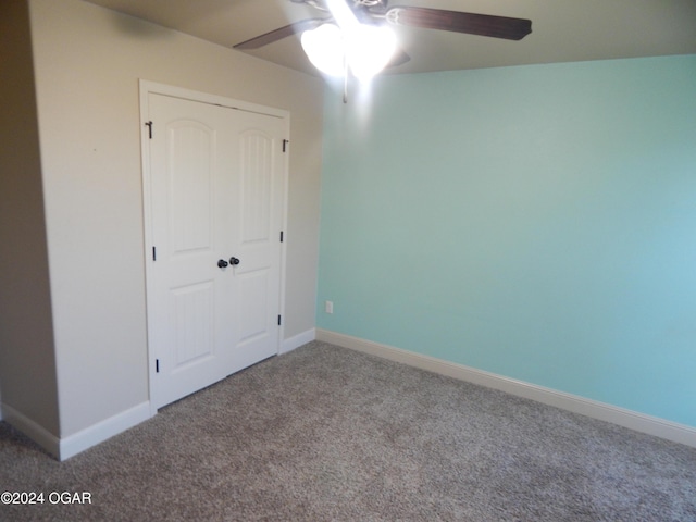 unfurnished bedroom with carpet, ceiling fan, and a closet