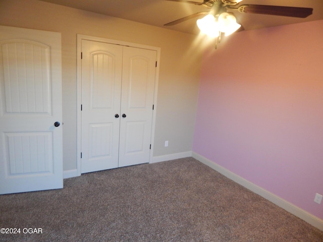 unfurnished bedroom featuring carpet floors, ceiling fan, and a closet