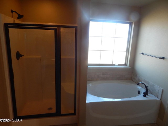 bathroom featuring separate shower and tub