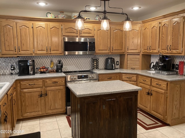 kitchen featuring hanging light fixtures, light tile patterned flooring, appliances with stainless steel finishes, and decorative backsplash