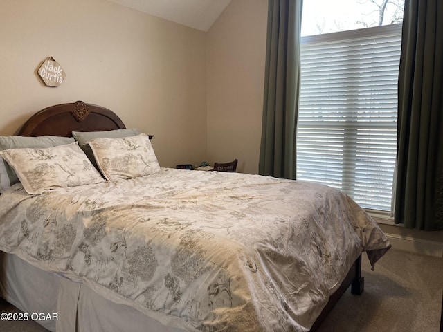 carpeted bedroom with lofted ceiling