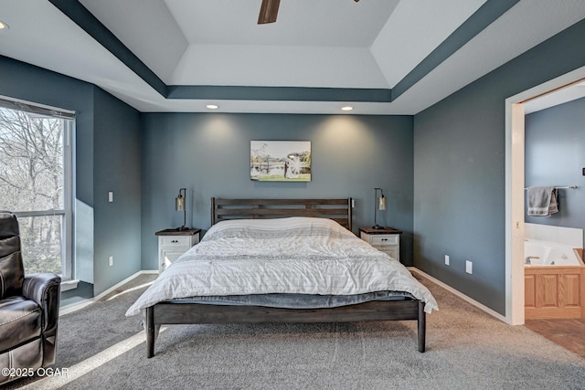 carpeted bedroom featuring a raised ceiling and ceiling fan