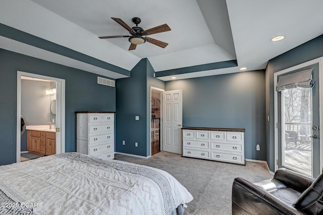 bedroom featuring ensuite bathroom, lofted ceiling, sink, access to outside, and light colored carpet