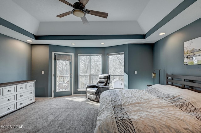 bedroom featuring a raised ceiling, carpet floors, access to outside, and ceiling fan