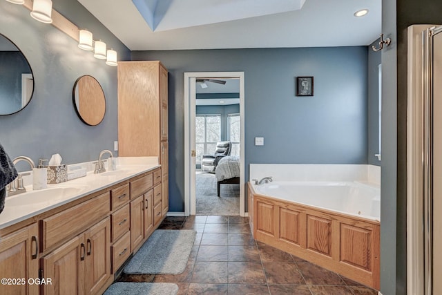 bathroom featuring vanity and a bath