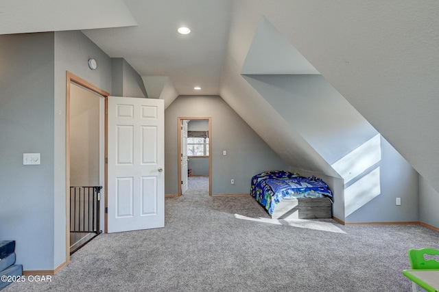 carpeted bedroom featuring lofted ceiling